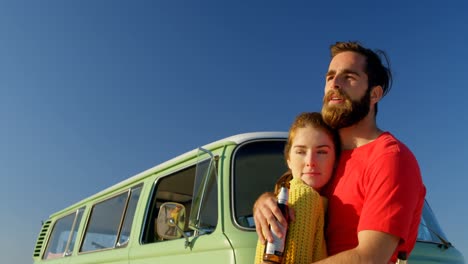 Young-couple-with-beer-bottle-embracing-each-other-4k