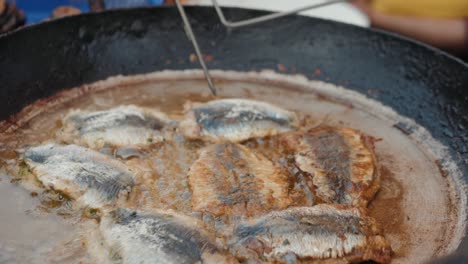 deep frying fish close up cooking on street ramadan kareem market