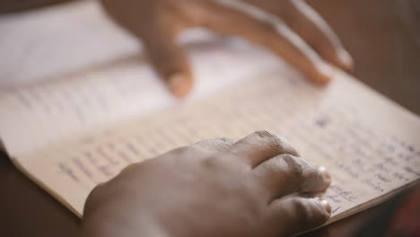 Close-up-footage-of-hands-on-a-journal