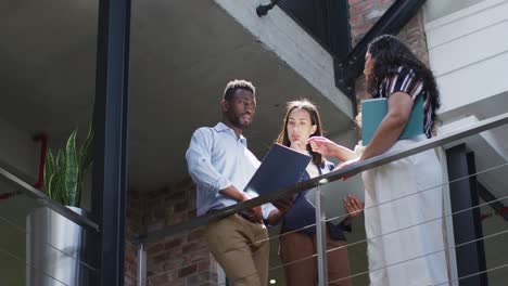 focused diverse group of business people working together, discussing work in modern office