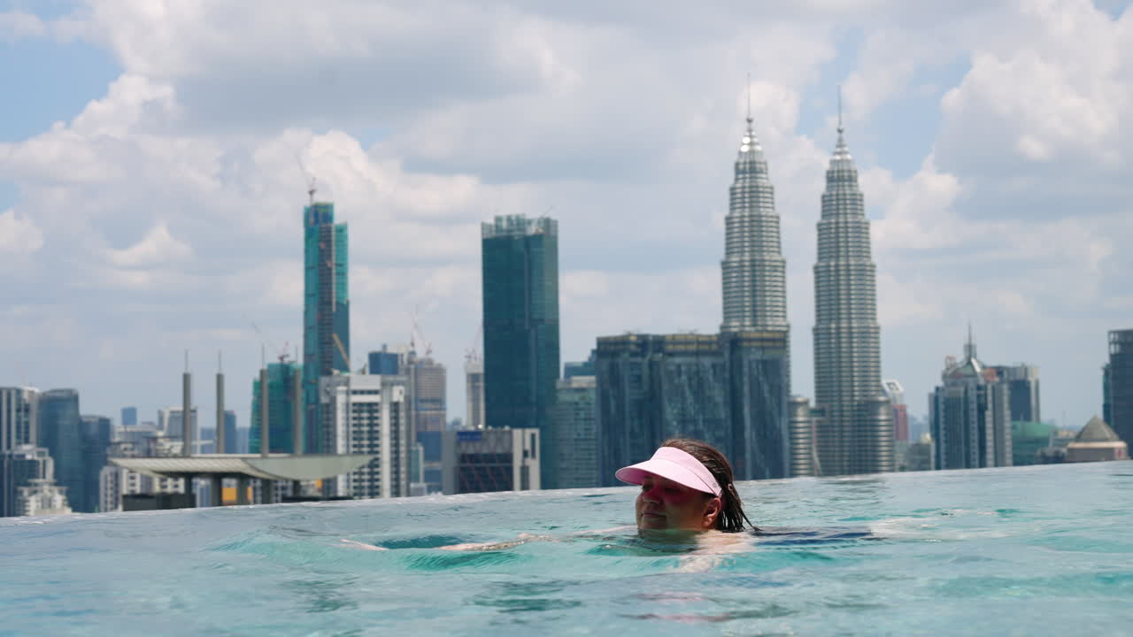 Portrait Of A Tourist On A Luxury Rooftop Swimming Pool In The City Of Kuala Lumpur In Malaysia