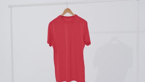 Video-of-red-t-shirt-on-hanger-and-copy-space-on-white-background