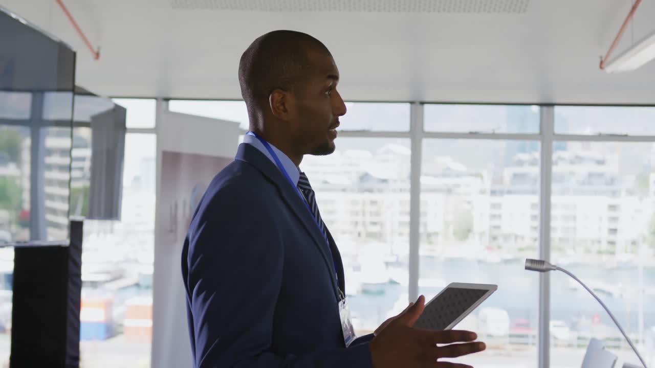 Male speaker addressing the audience at a business conference