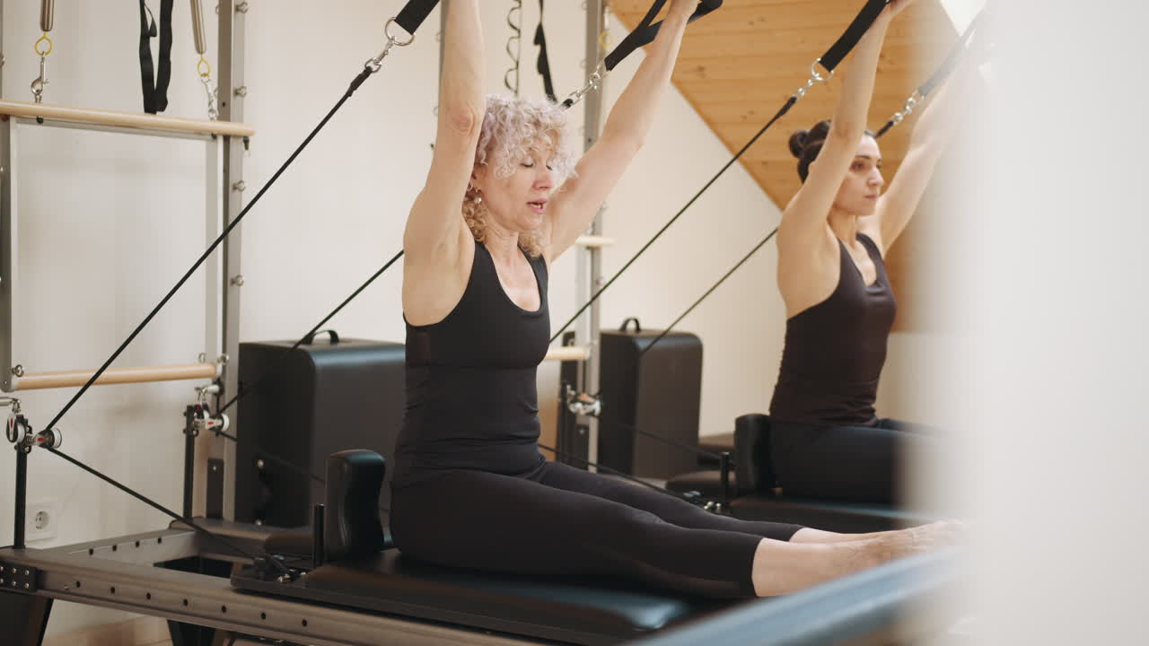 Allenamento Pilates Reformer con due donne