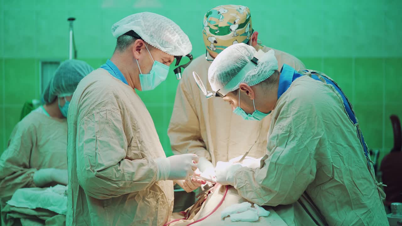 Three surgeons is performing complex surgery on the face of a person in the operating room. A nurse is helping surgeons with tools and materials.