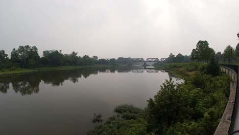 River-timelapse-on-a-foggy-smoky-day-with-bridge-in-background