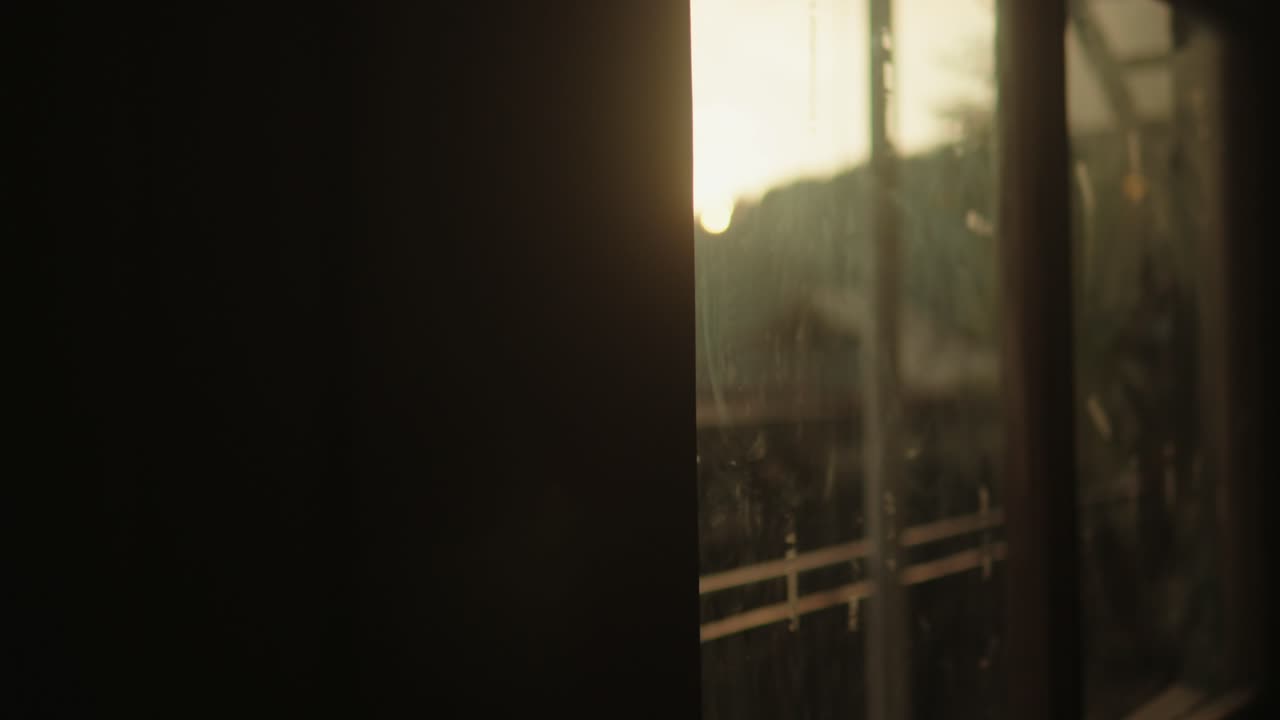 Blurred view through a rainy window during the sunset
