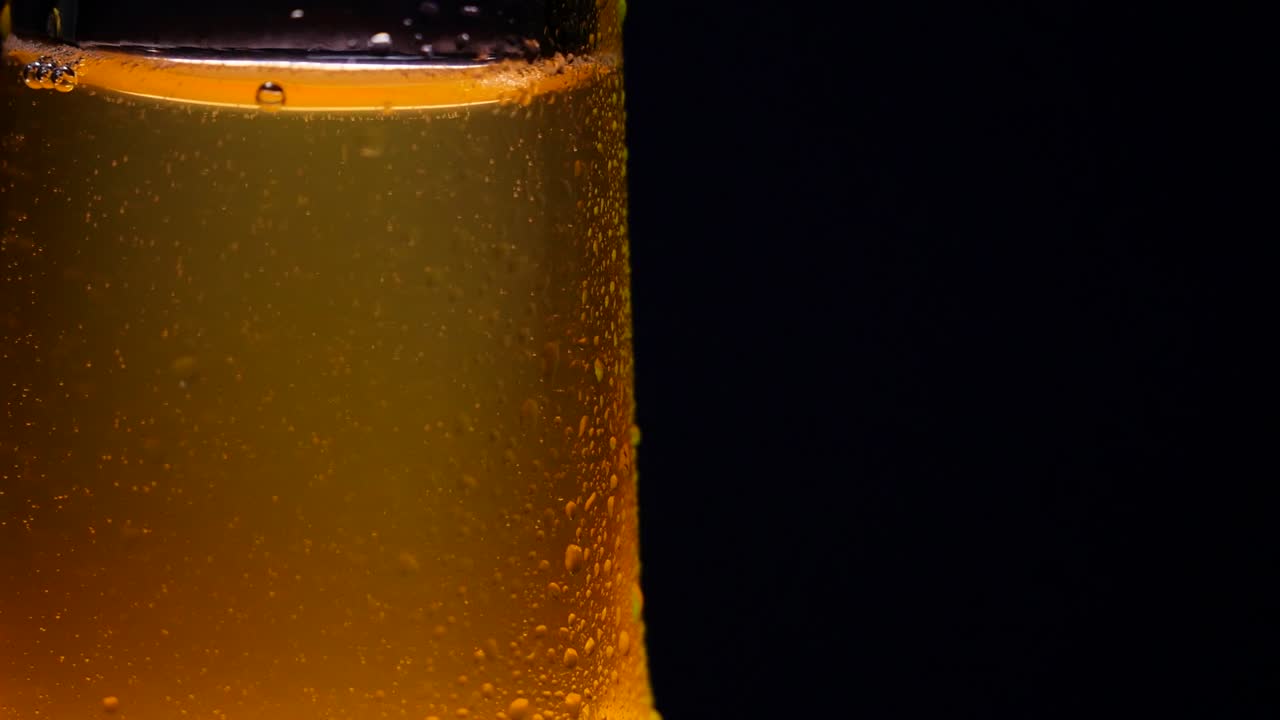 primer plano macro de burbujas de condensación en una botella de vidrio de cerveza ámbar