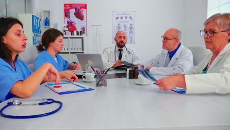 Group-of-medical-staff-discussing-in-hospital-meeting-room