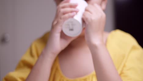 detail of asian woman drinking hot drink from cup