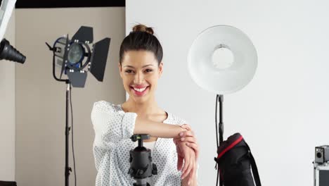 photographer standing with digital camera in studio