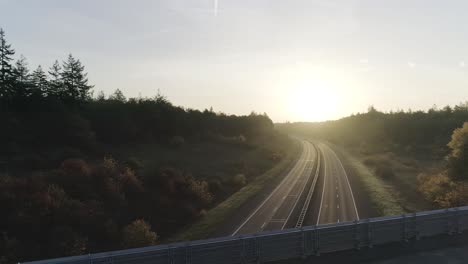 drone shots of mountainbiker riding over highway