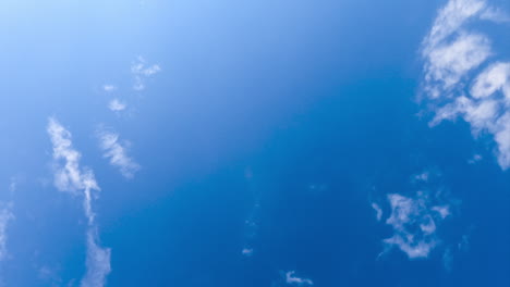 blue skies clearing up from white clouds. cloudscape formation in the horizon timelapse. view from below.