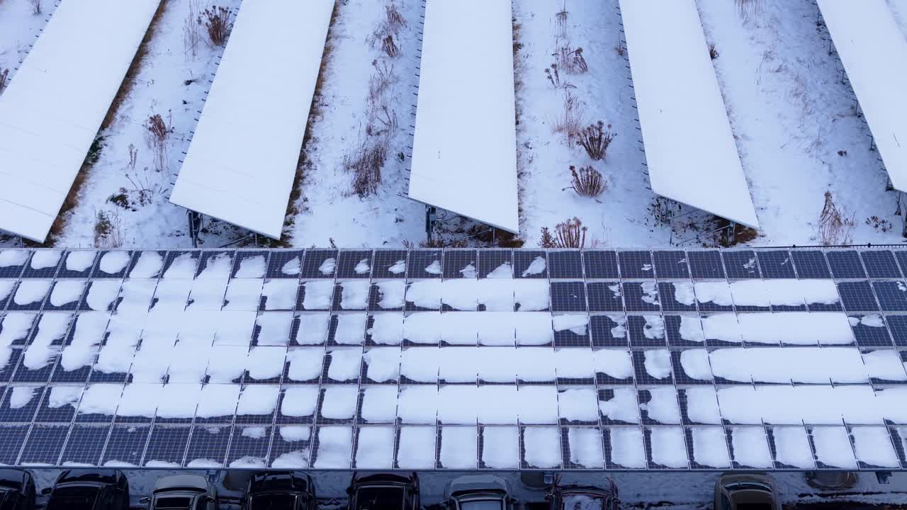 Aerial view of photovoltaic panels covered in snow in a clean energy power plant