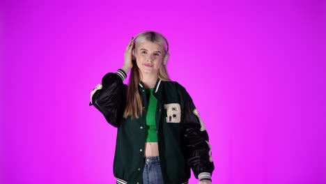 pretty young woman enjoys listening to music with headphones, purple background