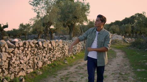 Serious-farmer-walking-summer-nature-closeup.-Sad-man-throwing-stone-vertically