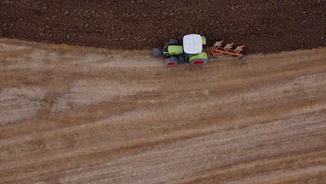 aerial drone monitoring of solo farmer tractor ploughing fields marche