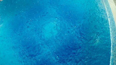 rain drops in the pool water, top slow motion view