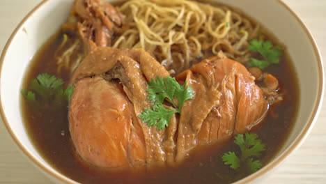 noodles with braised chicken in brown soup bowl - asian food style