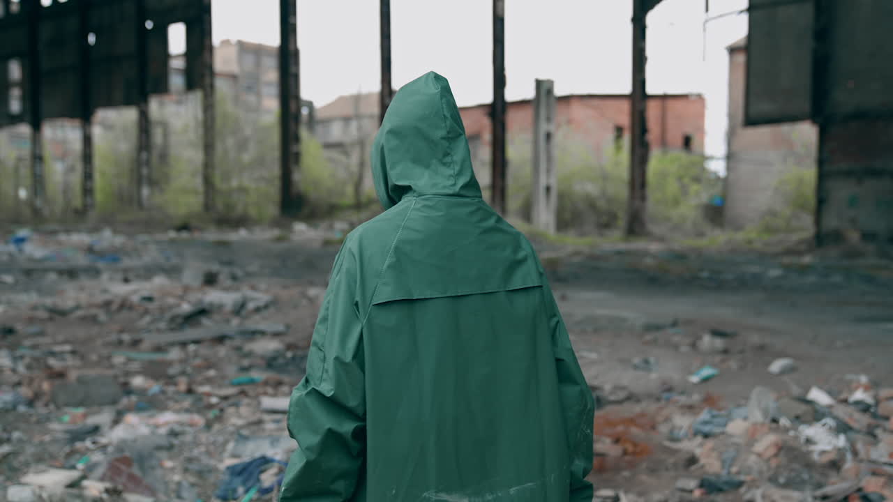 Environmental pollution and biological hazard. Human in gas mask near abandoned building