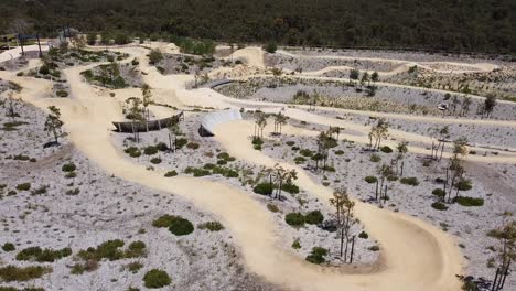 Ascending-aerial-view-over-new-mountain-bike-trails-at-Aduro-Park-in-Allara,-Perth