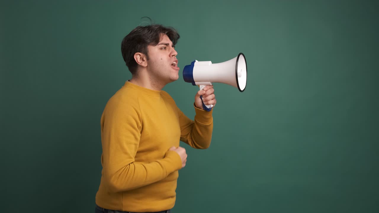 Upset caucasian man yelling using a loudspeaker