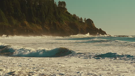 slow motion of foamy waves on a windy beach during sunrise