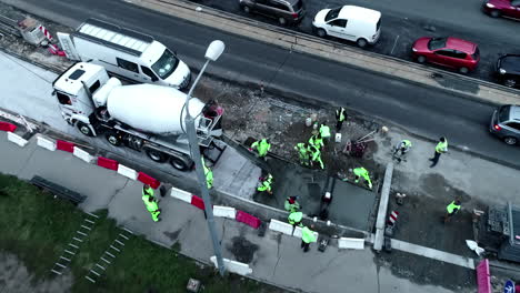 putting in a concrete city sidewalk slab - aerial view