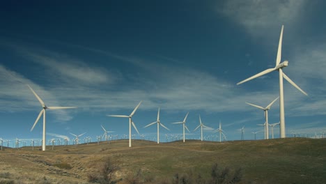 Wind-Turbines-Turn-Against-A-Blue-Sky-1