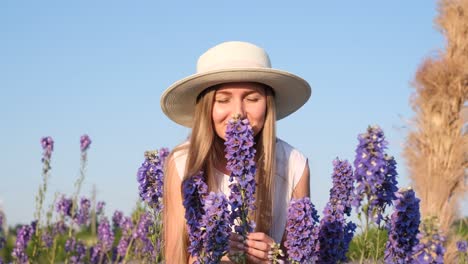 a woman in a white dress is walking through a field of purple flowers the scene is serene and a woman in a white dress is walking through a field of purple flowers the scene is serene and peaceful with the womans dress flowing in the wind the purple flowers create a beautiful