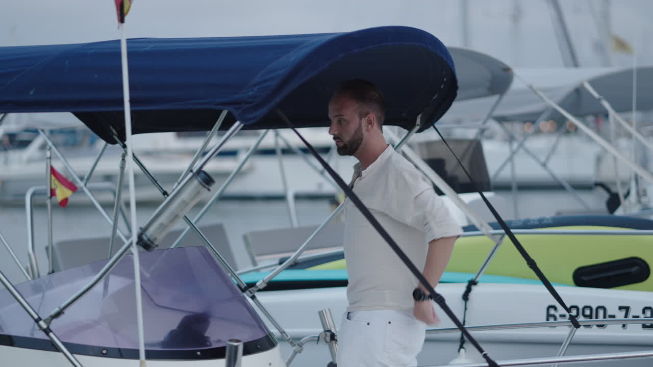 Man Preparing His Boat in a Marina