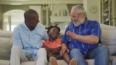 Senior-African-American-man,-his-son-and-grandson-spending-time-at-home-together.