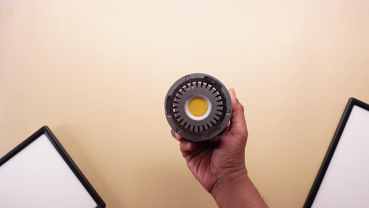 Hands Turning On and Off a COB LED Light