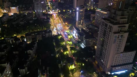 night time aerial over hangzhou downtown avenue and residential area, china