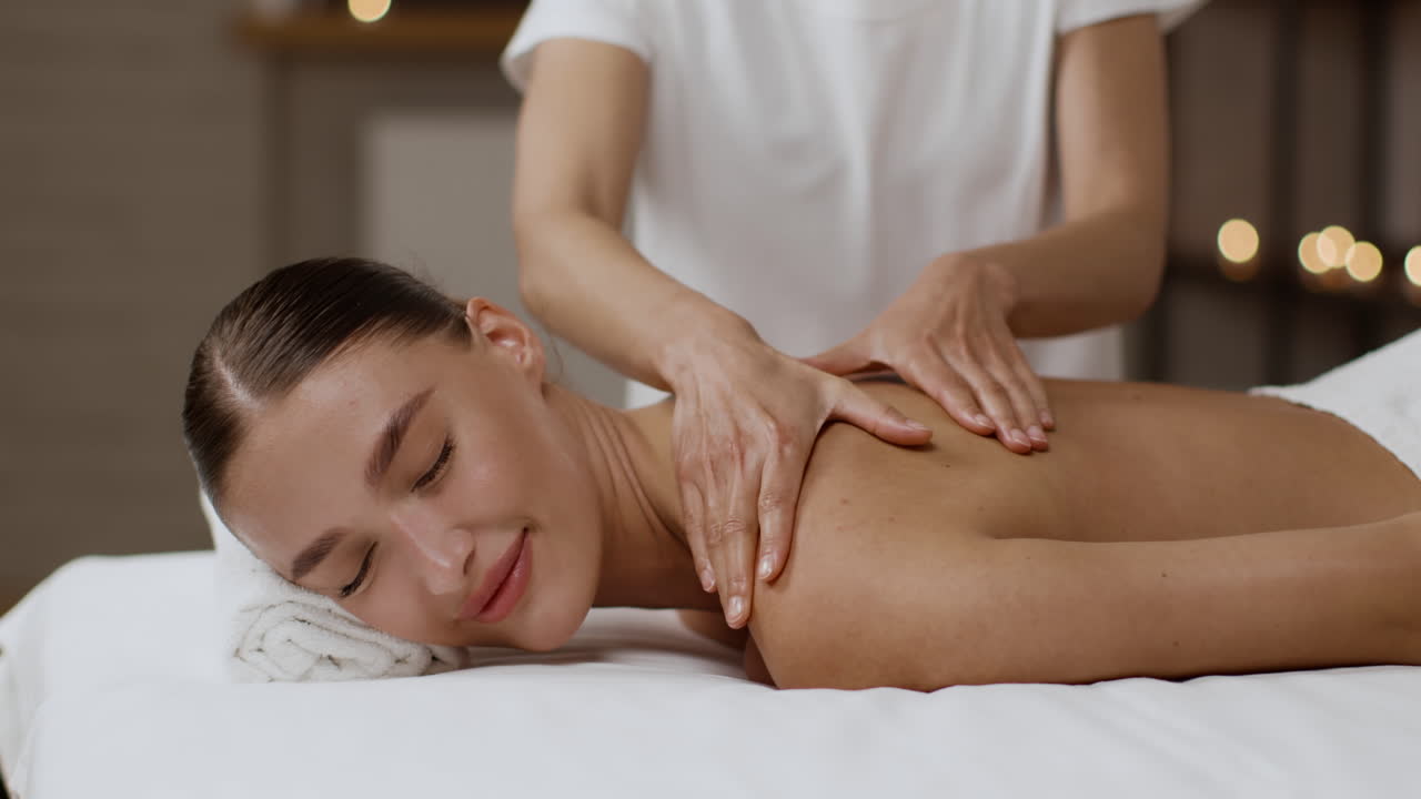 Woman Receiving a Shoulder and Back Massage at a Spa