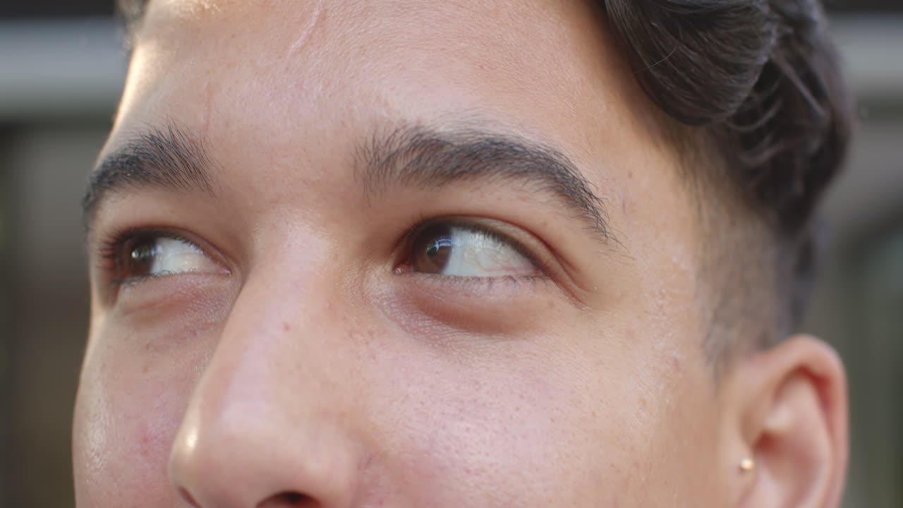 Close-up of person's face, showing thoughtful expression and focusing on details