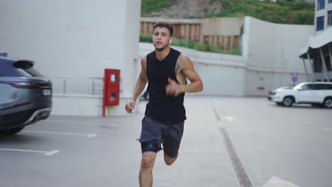 man runs outdoors on the parking garage, slowmo