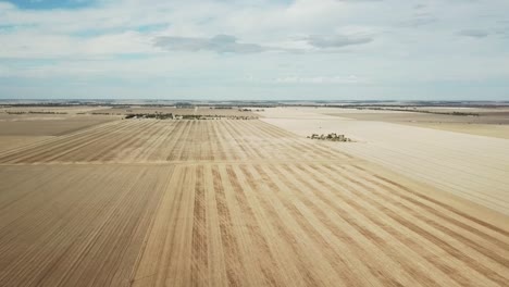 sideways aerial footage over dry paddocks after harvest near wedderburn, victoria, australia, may 2021.