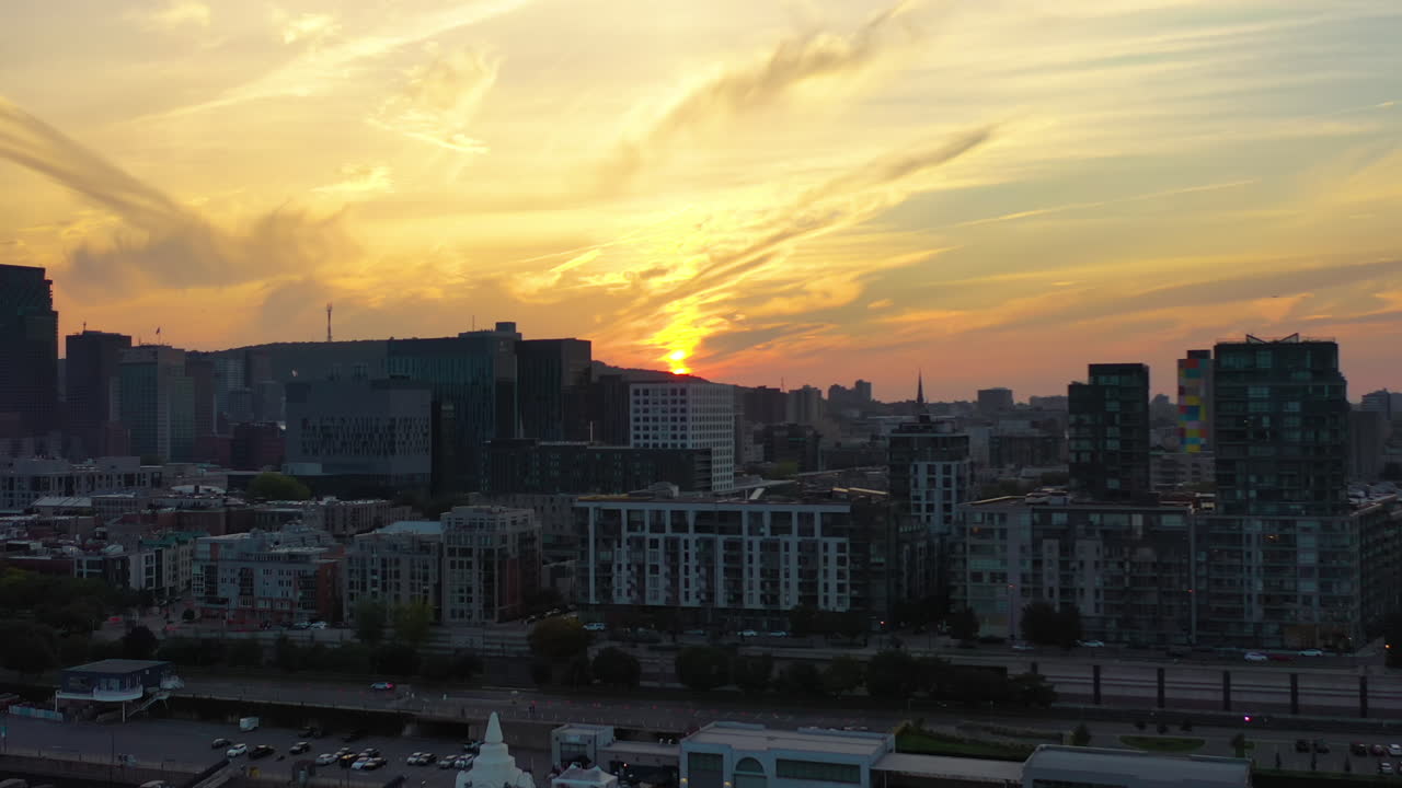 Drone rising over the Sailor's Memorial Clock and the city of Montreal, sunset