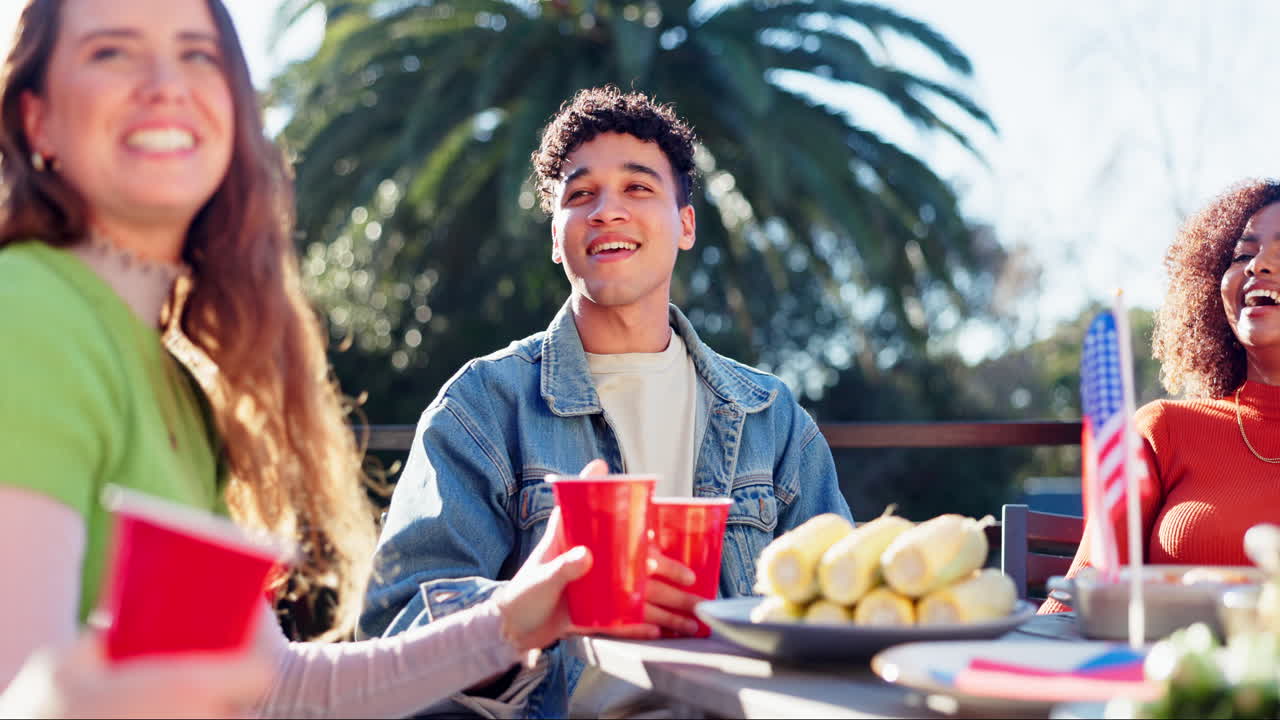 Friends celebrating outdoors with food and drinks
