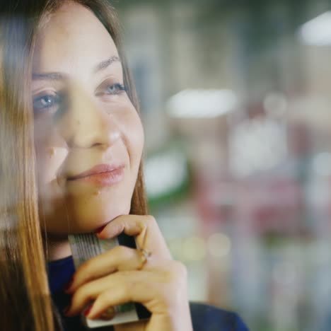 portrait of a young woman with a credit card in her hand