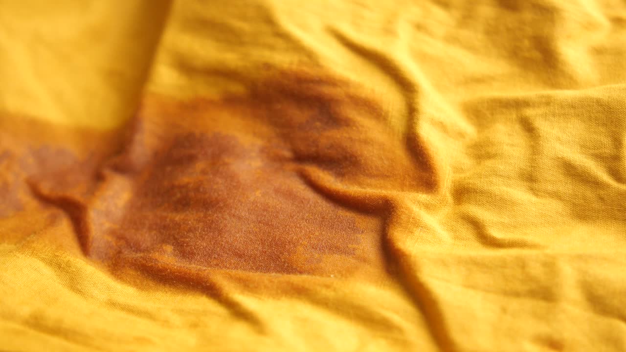 Yellow Fabric with Brown Stain