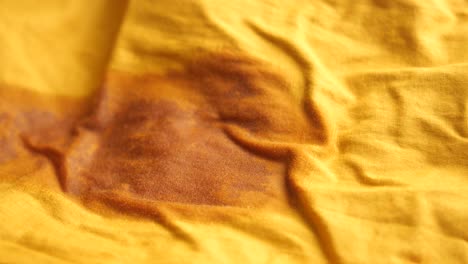 yellow fabric with brown stain