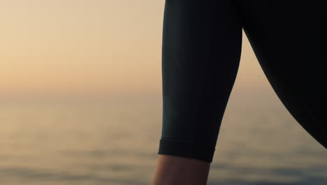 closeup stretching woman foot in front calm ocean. slim girl warming up body.