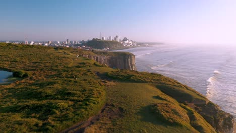 Cinematic-aerial-view-on-top-of-high-cliffs-trekking-path-at-sunrise-dawn