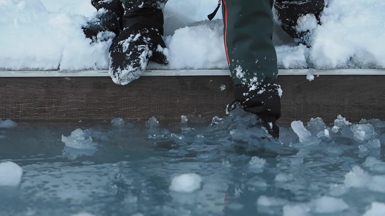 Person Touching Ice and Snow