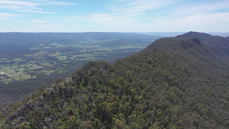 Aerial-approaches-sharp-Razorback-Ridge-high-above-green-valley-below