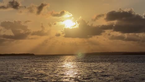 Stunning-landscape-shot-of-a-beautiful-golden-tropical-sunset-on-the-Guaraíras-Lagoon-from-the-famous-tourist-destination-Tibau-do-Sul,-Brazil-near-Pipa-in-Rio-Grande-do-Norte-on-a-summer-evening