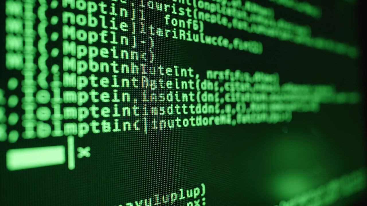 Close-up of green glowing computer code on dark screen