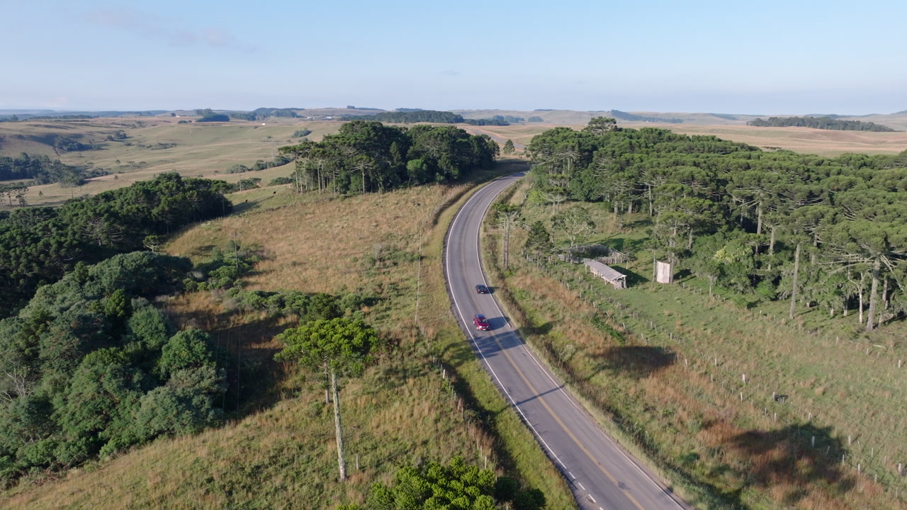 Campos de Cima da Serra aerial with rural road winding through highland fields in southern Brazil.